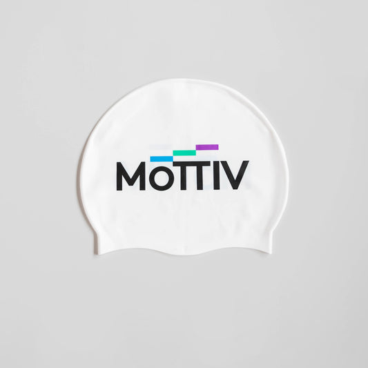 White silicone swimming cap with the MōTTIV logo on both sides